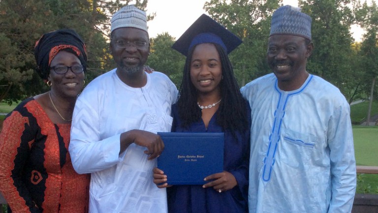 Chibok Girl with EMC sponsors showing her diploma